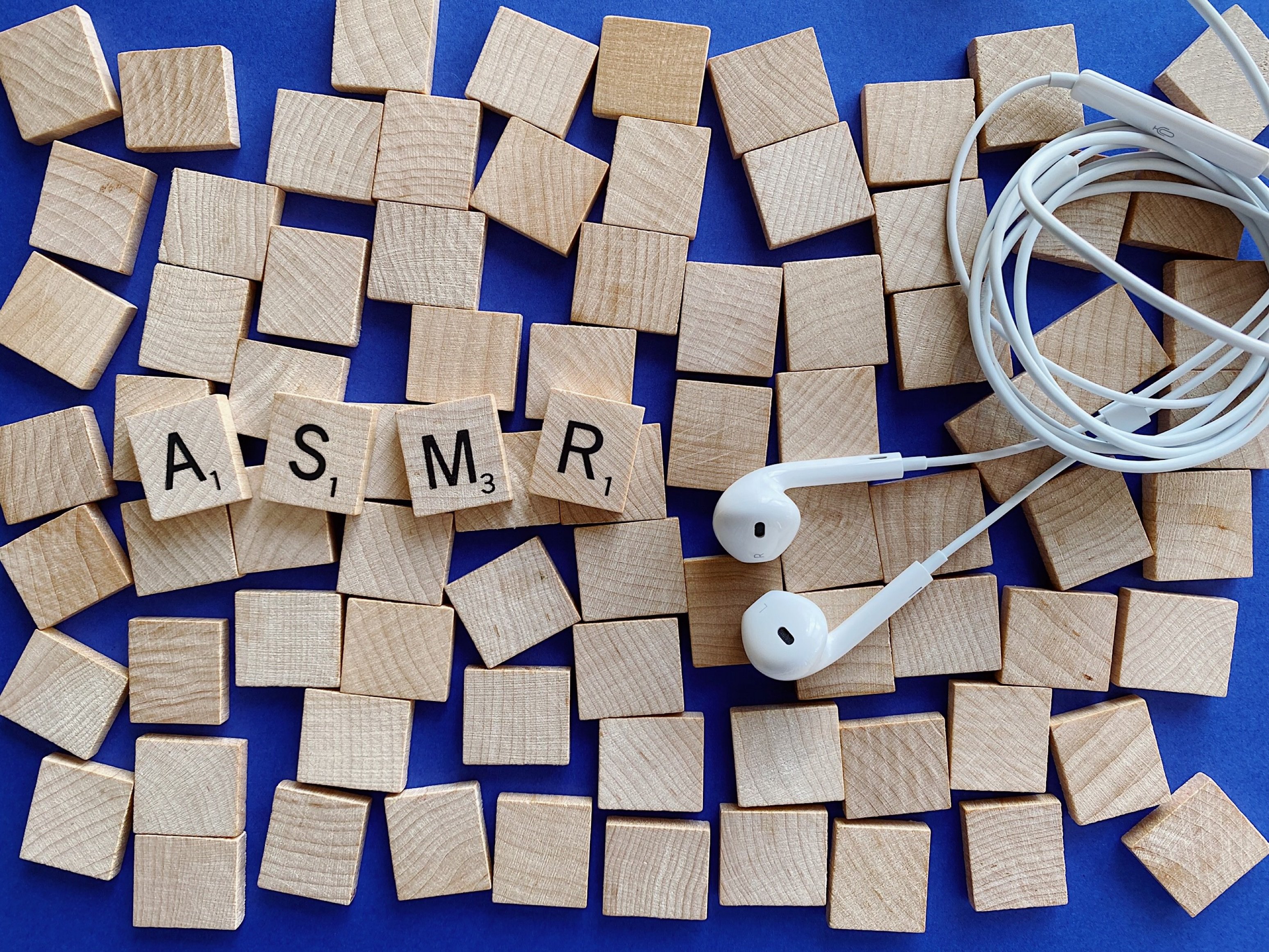 ASMR scrabble tiles and earphones — representing auditory sensory tools