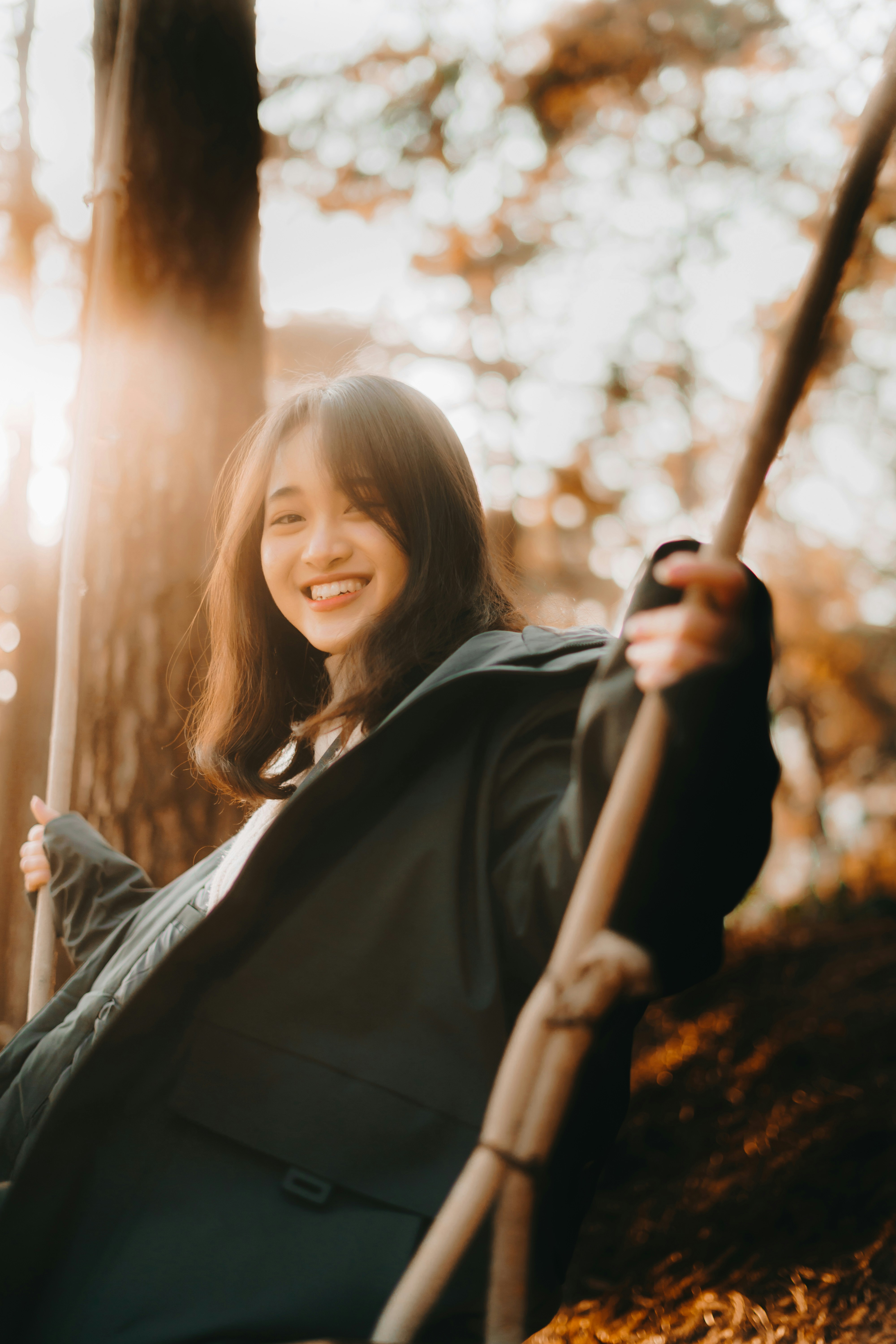 Person on a swing in golden autumn light — representing joy, movement and sensory wellbeing
